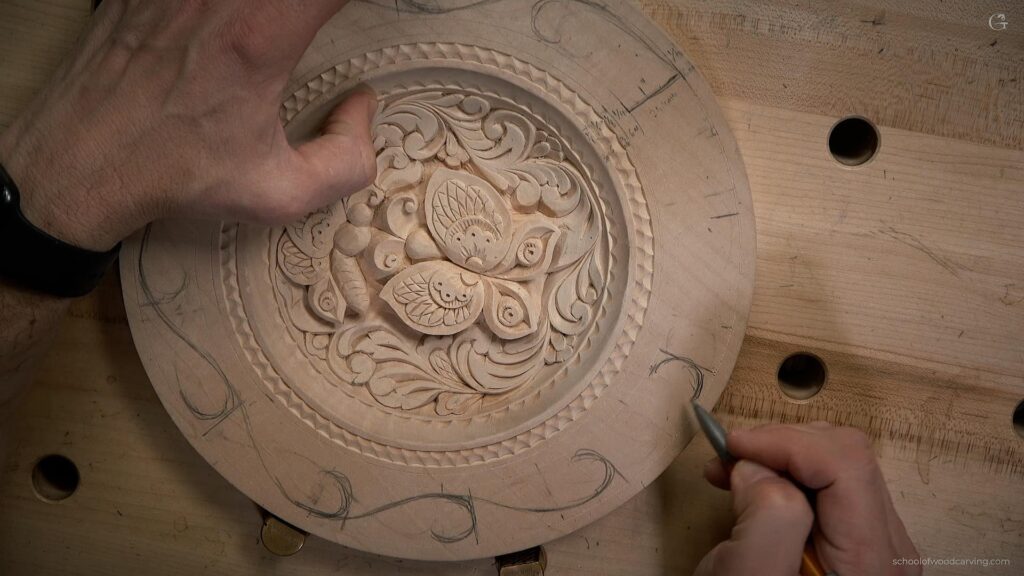 Alexander Grabovetskiy, a master wood carver, is captured in this photograph as he skillfully demonstrates the art of wood carving. With years of experience and expertise, Alexander is seen crafting intricate butterflies on a wooden plate, showcasing his talent and knowledge in the craft. The picture reveals his dedication and focus, as he carefully carves out delicate details, bringing the beautiful butterfly designs to life. Alexander Grabovetskiy's passion for wood carving is evident in his work. His expertise in using a carving knife, as well as other specialized tools, allows him to create captivating and realistic representations of butterflies on the wooden surface. Each butterfly is meticulously designed, with attention to detail, capturing the essence and beauty of these delicate creatures. The wooden plate itself serves as a canvas for Alexander's creativity, as he transforms a simple piece of wood into a stunning work of art. In this image, viewers can also gain insight into Alexander's teaching methods. His hands-on approach to sharing his knowledge of wood carving techniques, such as selecting the right type of wood, using carving tools correctly, and understanding the intricacies of the design process, is evident. This picture not only showcases his talent but also highlights the importance of learning from an experienced professional to develop one's own skills in the craft. As Alexander Grabovetskiy works on the wooden plate, it becomes clear that he is passionate about not only creating beautiful pieces but also preserving the rich history and tradition of wood carving. He believes in passing on this invaluable knowledge to aspiring wood carvers, ensuring the continuation of this ancient art form for future generations to enjoy. This captivating photograph of Alexander Grabovetskiy creating a butterfly design on a wooden plate is a testament to his skill, expertise, and dedication to the art of wood carving. It serves as an inspiration to those interested in pursuing this craft, and a reminder of the beauty and intricacy that can be achieved through patience, practice, and unwavering passion for the art form.