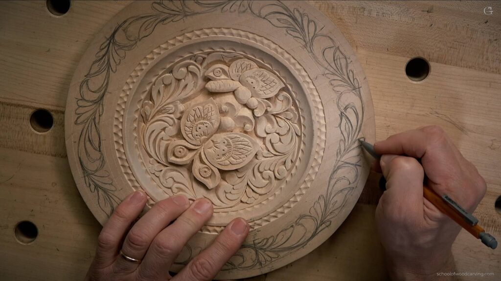 A skilled artisan carefully carving an intricate butterfly design on a wooden plate using a precise carving knife.