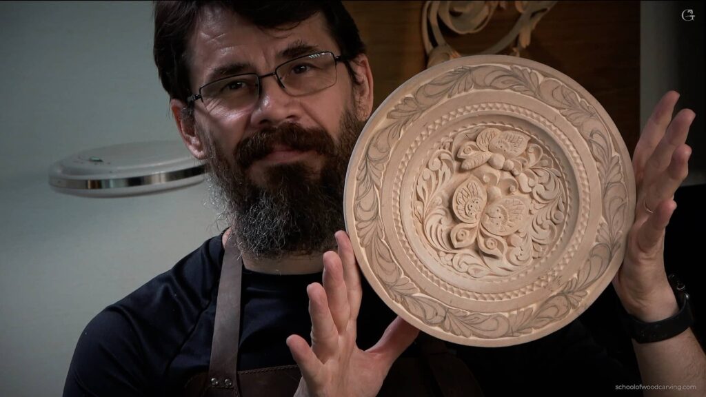 Alexander Grabovetskiy, an accomplished wood carving artist, proudly displays his intricately carved plate featuring two delicate butterflies. Using only a carving knife, he expertly crafted this stunning piece from American Basswood, also known as Limewood, Lindenwood, or Tilia. As a testament to his skill, he transformed the wood into a captivating work of art that showcases his attention to detail and mastery of wood carving techniques. Alexander Grabovetskiy is renowned for his incredible talent in wood carving, an art form that requires precision, patience, and creativity. In this remarkable piece, he has chosen American Basswood as his canvas, which is a popular choice among wood carvers due to its soft texture, straight grain, and minimal knots. Basswood, alternatively called Limewood, Lindenwood, or Tilia, is particularly well-suited for intricate and detailed carvings like the ones seen in Alexander's breathtaking plate. The plate itself is a testament to Alexander's dedication to the craft, as he used only a single tool - a carving knife - to create this intricate work of art. By skillfully manipulating the knife, he was able to bring the two butterflies to life, their wings poised as if caught mid-flight. The butterflies are rendered with such precision that they seem almost ready to take flight from the plate, capturing the delicate balance between nature and artistry. As a master wood carver, Alexander Grabovetskiy's expertise is evident in the fine details of the plate's design. The butterflies' wings showcase an array of patterns, with each tiny line carefully etched into the wood. It is this meticulous attention to detail that sets his work apart and makes it so captivating to behold. In addition to the butterflies, the plate's border is adorned with a beautifully carved leafy pattern that encircles the entire piece. This subtle yet elegant touch adds depth and visual interest to the overall composition, drawing the viewer's eye around the plate and inviting them to appreciate the craftsmanship from every angle. The choice of American Basswood as the material for this piece speaks not only to its suitability for carving but also to the rich history of wood carving in America. By working with this versatile and abundant wood, Alexander Grabovetskiy is able to connect with a long lineage of talented artisans who have honed their skills over generations, passing down their knowledge and techniques to create stunning works of art like this hand-carved plate. This exquisite piece by Alexander Grabovetskiy is a shining example of the beauty and craftsmanship that can be achieved through wood carving. It is an ode to the power of human creativity and the ability to transform raw materials into something transcendent. Through the careful application of his carving knife, Alexander has breathed life into a simple piece of American Basswood, transforming it into a mesmerizing work of art that is sure to captivate and inspire all who have the pleasure of witnessing it.