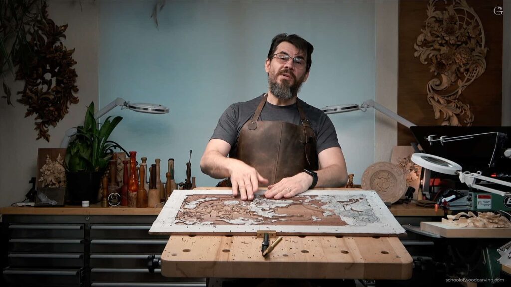 In this inspiring image, you can witness a masterclass as Alexander Grabovetskiy, a renowned woodcarver, skillfully demonstrates how to carve a furniture panel by hand. If you're yearning to learn how to carve for furniture, this picture offers a glimpse into the mesmerizing world of woodcarving. A walnut panel is being meticulously carved in the photograph. Walnut wood, with its rich hues and fine texture, is the epitome of elegance and luxury. Alexander Grabovetskiy's expert hands are seen here turning this simple piece of wood into a majestic work of art. This beckons any aspiring woodcarver to seek lessons on how to carve for furniture, specifically to create panels that radiate finesse and timeless beauty. What sets this photograph apart is that it’s not just a demonstration, but an invitation to learn from the School of Wood Carving. Alexander Grabovetskiy’s School of Wood Carving offers an array of woodcarving lessons that delve into the intricacies of carving panels, among other subjects. For those who wish to learn from the comfort of their home, the School of Wood Carving also offers wood carving video workshops. These workshops are treasure troves for both novices and seasoned carvers, looking to refine their skills. In the picture, Grabovetskiy is seen employing various tools, each with its unique role in breathing life into the walnut panel. His attention to detail and the graceful fluidity of his carvings are reflective of his vast experience and mastery. This reflects the depth and quality one can expect from woodcarving lessons imparted by Woodcarver Grabovetskiy. The panel in the photograph is a testament to the 18th-century style, known for its ornate and intricate designs. If learning how to create such stunning designs is your calling, the School of Wood Carving is your haven. With lessons curated and taught by Alexander Grabovetskiy, one of the most esteemed names in the woodcarving community, this is an opportunity like no other. In essence, this photograph is not just an image but an inspiration to embark on a journey to learn how to carve a furniture panel. With Alexander Grabovetskiy as your guide and mentor, the School of Wood Carving offers a plethora of woodcarving lessons and wood carving video workshops, opening the gates to a world where wood comes alive under the caress of a carver's hands. Whether you aspire to craft panels, furniture, or simply wish to immerse yourself in the art of woodcarving, learning from a maestro like Alexander Grabovetskiy is the path to realizing those dreams. The walnut panel carved by hand in the photograph is a mere glimpse into what you can achieve with the right guidance and passion. Take the first step into a world where every piece of wood holds the promise of a masterpiece waiting to be uncovered.