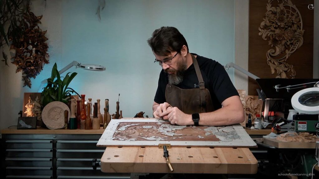 A close-up of a wood carving in progress. The artist's hands skillfully maneuver a gouge over the surface, shaping concave and convex curves. The wood grain adds depth and texture to the intricate design, showcasing the artist's craftsmanship.
