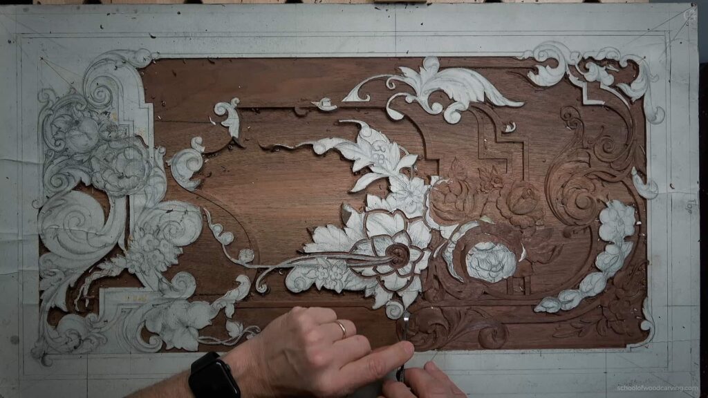 A close-up of a wood carving in progress. The artist's hands skillfully maneuver a gouge over the surface, shaping concave and convex curves. The wood grain adds depth and texture to the intricate design, showcasing the artist's craftsmanship.