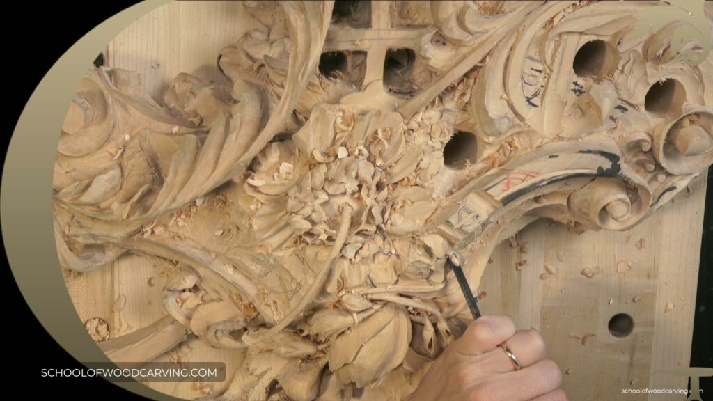 A person is carving a piece of wood in the Grinling Gibbons style.