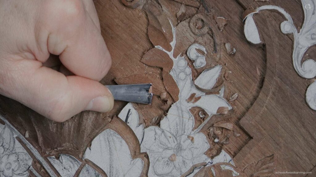 A person is using a knife to carve a piece of wood.