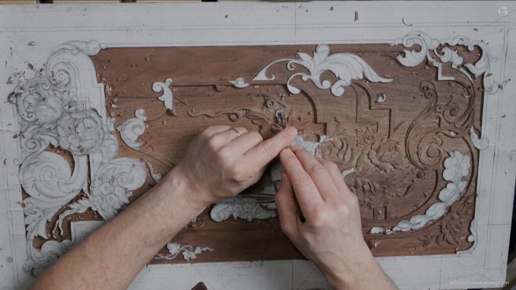 A person is carving a piece of wood.