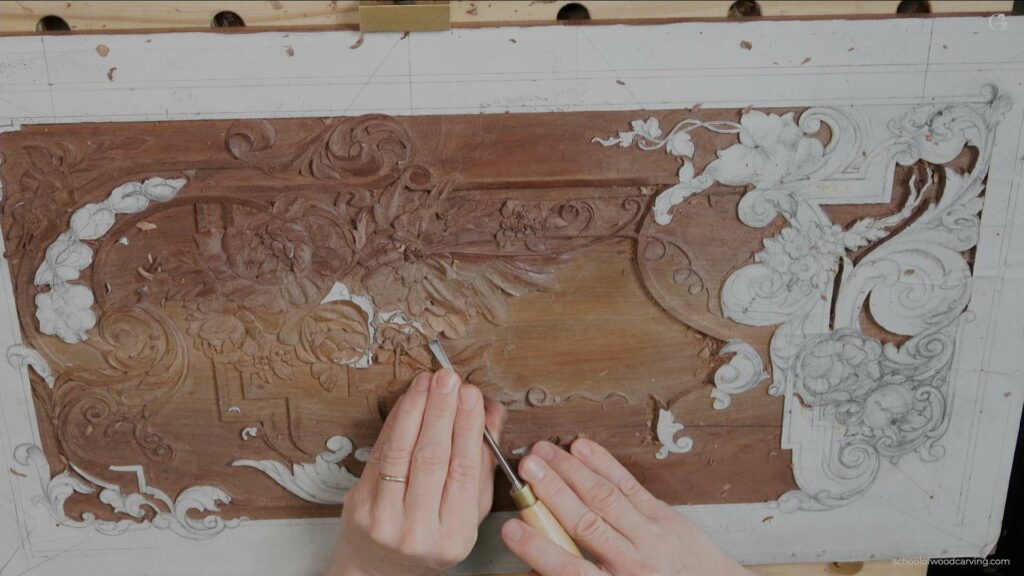 A person carving a wood surface.
