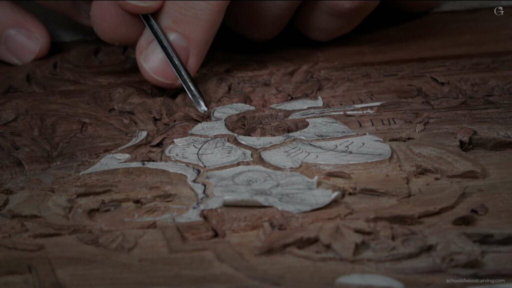 A person is carving a piece of wood.