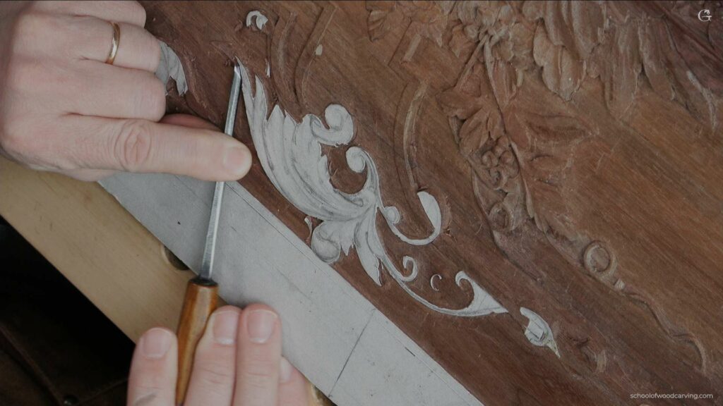 A person carving a piece of wood.