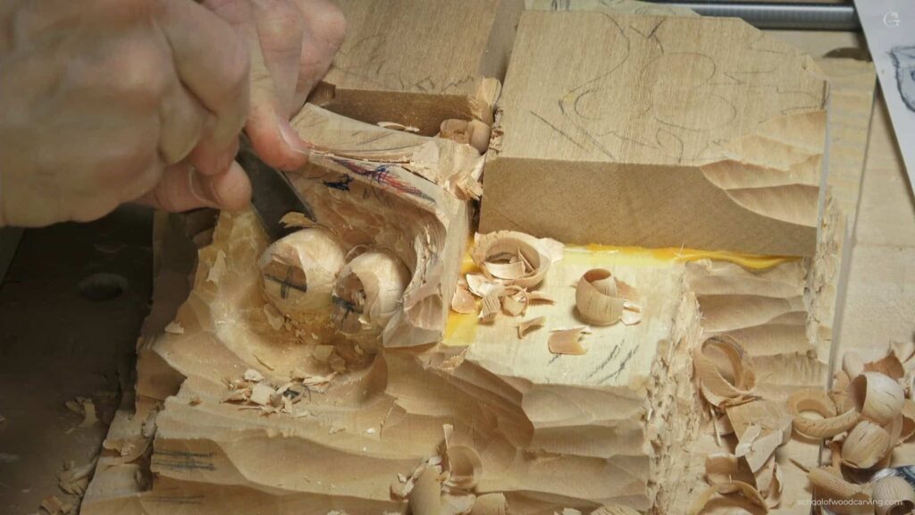 WOODCARVING LESSONS: Woodcarver Grabovetskiy uses a chisel to carve eye shapes in wood. Shavings and pencil lines show his carving process step-by-step. - Wood Carving tutorials